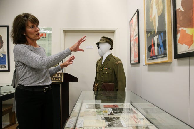 Susan Wilkins, director of education, talks about some recruitment posters by Abram Games as part of the new exhibit, "Women in WWII: On the Home Fronts and the Battlefronts", at the International Museum of World War II in Natick on Tuesday. [Daily News and Wicked Local Photo/Dan Holmes]