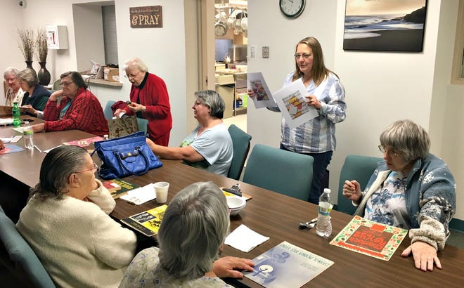 Sharon Tomassetti from the Wayne Center for the Arts explains an art project to a group of senior citizens gathered at the Salvation Army in Wooster.