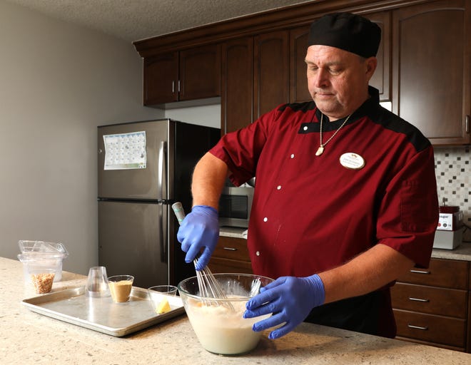 Lexington Place Dining Services Director John Buchanan prepares coconut cream parfait. [News-Journal/Nigel Cook]