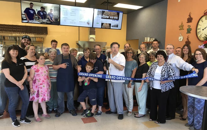 The Greater Rochester Chamber recently held a ribbon cutting to welcome The Potter's House Bakery & Cafe. The Potterís House Bakery & Cafe, located at 10 Chestnut Hill Road, provides homemade baked goods and roasted coffee and also provides job training for young adults on the Autism spectrum. [Courtesy photo]

Cutting the ribbon in the photo is owner Tim Willson along with family members, students, Chamber, City and State representatives. 

For more information, call 603-948-1229 or visit www.pottershousebakery.com.