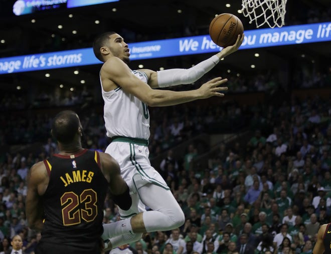 Boston Celtics forward Jayson Tatum (0) glides to the basket over Cavs forward LeBron James during Wednesday night's Game 5 of the Eastern Conference Finals. [Charles Krupa/AP]