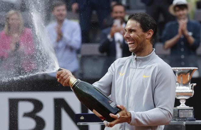 Spain's Rafael Nadal sprays sparkling wine as he celebrates defeating Germany's Alexander Zverev in the final match of the Italian Open on Sunday. Nadal is 79-2 for his career in the French Open, a .975 winning percentage. [AP PHOTO/GREGORIO BORGIA]