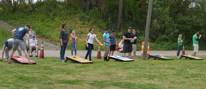 Contestants throw bean bags during the Petersburg Rotary Club's cornhole tournament on Saturday, May 5. [Contributed Photo]
