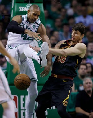 Boston's Al Horford (42) and Cleveland's Kyle Korver (26) compete for a loose ball during the second quarter.
