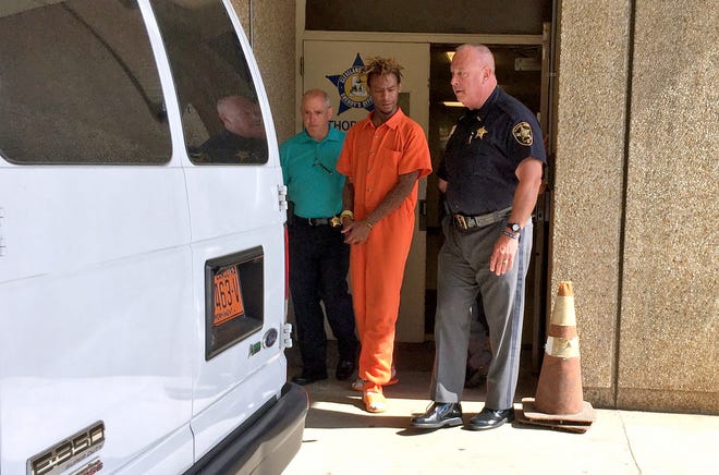 Murder suspect Garrett Clay Fredrick 

is led out of the courthouse by Sheriff Alan Norman, right, and Lt. Tracy Curry. [Diane Turbyfill/The Star]