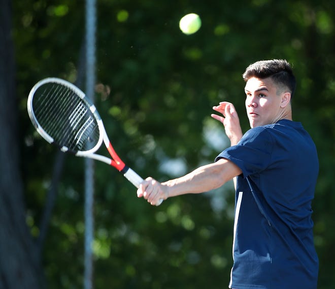 Cohasset's No. 1 doubles player Ryan Chomphunut eyes his backhand volley at the net during his match against Hingham at the Milliken tennis courts on Monday, May 21, 2018. [Wicked Local Staff Photo/ Robin Chan]