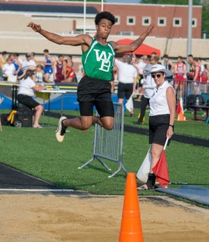 David McKeiver of West Branch launches himself though the air in the long jump at the Division II Regional Track and Field Meet at Austintown Fitch on Thursday.