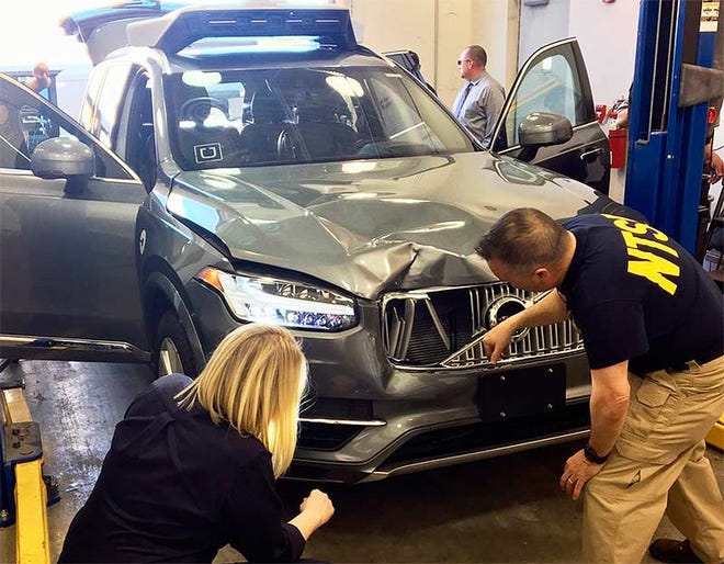 National Transportation Safety Board investigators in March examine a driverless Uber SUV that fatally struck and killed a woman in Tempe, Ariz. [NTSB]