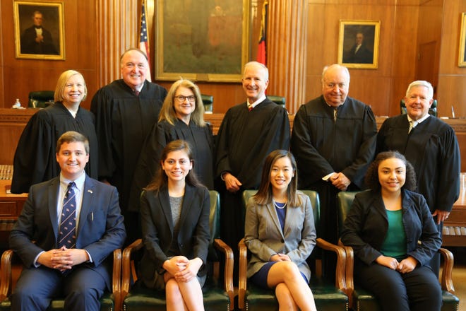 The North Carolina Moot Court Competition finals were contested between two teams from the Highland School of Technology in Gastonia on May 4 in Raleigh. Pictured front row from left, champions Joseph Buckner and Julia Murrow and runners-up Sara Jane Heavner and Patience Foster. In the back row from left are Judges Lucy Inman and John Tyson from the N.C. Court of Appeals, Justices Barbara Jackson and Paul Newby from the N.C. Supreme Court, and Judges Robert Hunter and John Arrowood from the N.C. Court of Appeals. [NORTH CAROLINA BAR ASSOCIATION/SPECIAL TO THE GAZETTE]