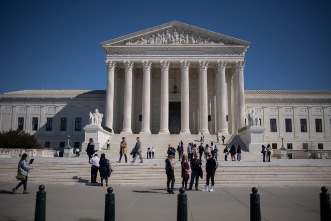 Visitors stand outside the U.S. Supreme Court in Washington on Feb. 27, 2018. MUST CREDIT: Bloomberg photo by Ron Antonelli.