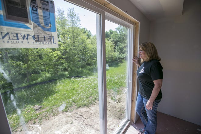 Mayor Jodi Miller looks out the back window of the first new home built in Freeport in 10 years after a ribbon-cutting ceremony Thursday, May 24, 2018. [ARTURO FERNANDEZ/THE JOURNAL-STANDARD STAFF]
