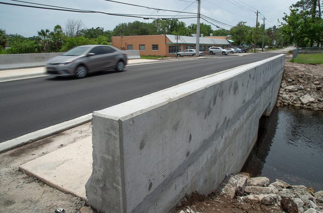 A car crosses the newly reopened Oyster Creek bridge on South Dixie Highway in St. Augustine on Tuesday. The road had been closed since January to replace the bridge. [PETER WILLOTT/THE RECORD]