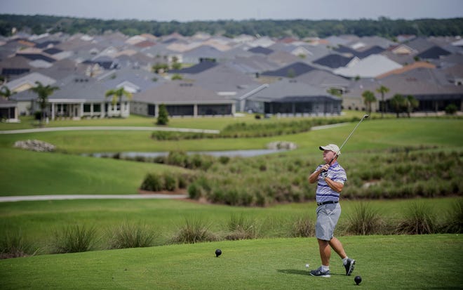 In a Tuesday photo, Rick Rexrode, of the Village of Pine Ridge, tees off at the Escambia Executive Golf Course in the Fruitland Park area of The Villages. Fruitland Park was recently named the fastest-growing city in Florida. [Cindy Skop/The Villages Daily Sun via AP]