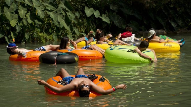 Jorge Rosas of Houston relaxes in the San Marcos River during Float Fest. JAY JANNER / AMERICAN-STATESMAN
