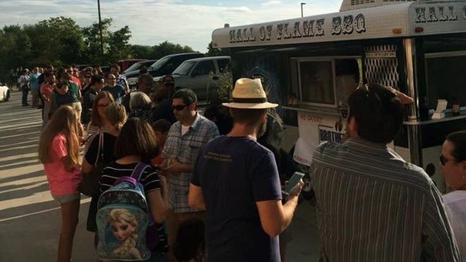 John Brotherton, owner of Brotherton’s Black Iron Barbecue at Pecan Street and Springhill Lane, got his start with a food truck, which would attract long lines while parked in front of The Growler Bar on FM 685. File photo