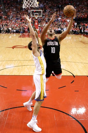 Houston Rockets guard Eric Gordon, right, shoots past Golden State Warriors guard Klay Thompson during the first half in Game 5 of the NBA basketball playoffs Western Conference finals in Houston, Thursday, May 24, 2018. (AP Photo/David J. Phillip)