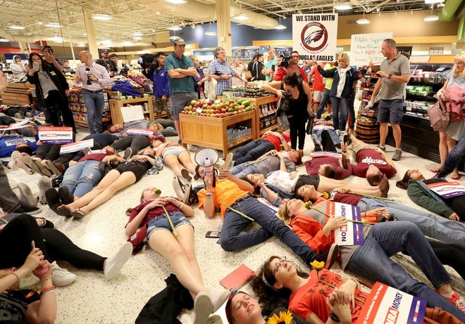 Demonstrators lie on the floor at a Publix Supermarket in Coral Springs on Friday. Students from a Parkland high school, where 17 people were shot and killed earlier this year, did a "die in" protest at the supermarket chain for backing Adam Putnam, a gubernatorial candidate allied with the National Rifle Association. Shortly before the the "die-in," Publix announced that is will suspend political donations.