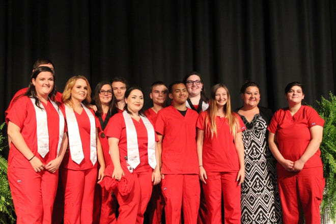 Graduates of Locklin's nursing program take on last group photo together after the ceremony on May 22. [KEVIN BOYER | Press Gazette]