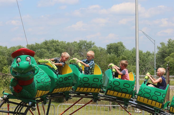 Carter Hittle, 6, Maxtin Kelly, 8, Owen Hittle, 5, and Trentin Kelly, 9, all of Zanesville, ride the gator coster at the 2017 Bolivar Strawberry Festival. (TimesReporter.com file / Jim Cummings)