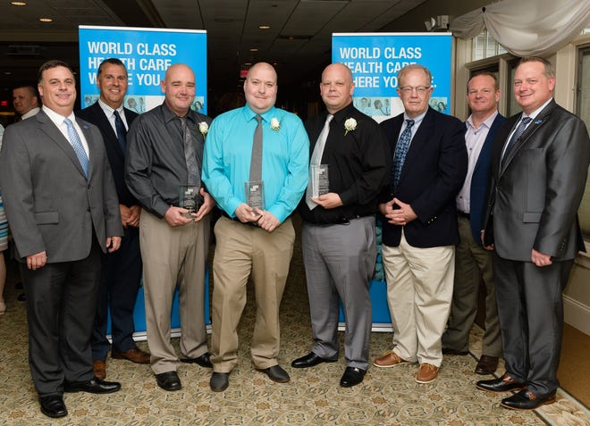 Pictured, from left, are John Harrell, EMS manager, Morton Hospital; Jeffrey Begin, Brewster Ambulance; John Smith; Tyler Medeiros; Brian Anderson; Dr. Charles Thayer, chief medical officer, Morton Hospital; Mark Brewster, Brewster Ambulance; and Brenden Hayden, VP of EMS, Steward Health Care. [Courtesy Photo]