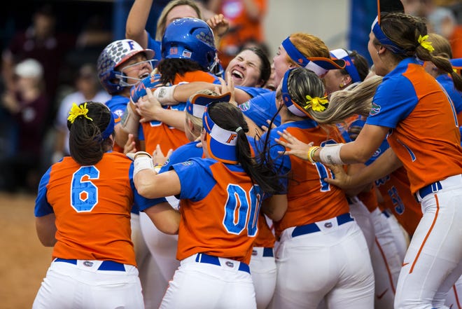 The Florida Gators celebrate their 5-3 win over Texas A&M in the NCAA Super Regional on Saturday at Katie Seashole Pressly Stadium in Gainesville. [Cyndi Chambers / Gatehouse Media]