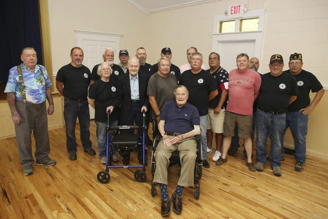 This photo provided by the office of former President George H.W. Bush, shows Bush posing with veterans during the monthly pancake breakfast at the American Legion Post 159 in Kennebunkport, Maine, on Saturday, May 26. [Office of former President George H.W. Bush via AP]
