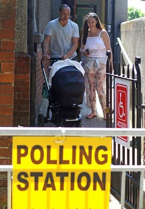 A family leave a polling station after voting in the referendum on the 8th Amendment of the Irish Constitution, in Dublin, Ireland, Friday. The referendum on whether to repeal the country's strict anti-abortion law is being seen by anti-abortion activists as a last-ditch stand against what they view as a European norm of abortion-on-demand, while for pro-abortion rights advocates, it is a fundamental moment for declaring an Irish woman's right to choose.