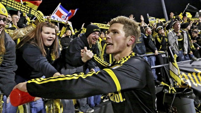 Columbus Crew SC captain and midfielder Wil Trapp celebrates with fans after a 2015 playoff win. The Ohio-born Trapp said he and his teammates have been insulated from the off-the-field news that the Crew might move to Austn in 2019. FRED SQUILLANTE/THE COLUMBUS DISPATCH