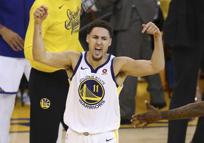 Golden State Warriors guard Klay Thompson (11) celebrates during the second half of Game 6 of the NBA Western Conference Finals against the Houston Rockets in Oakland, Calif., on Saturday. [AP Photo / Ben Margot]