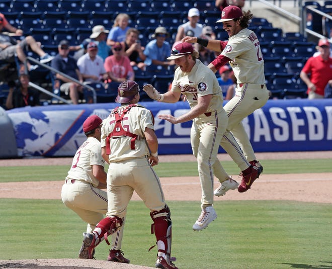 From left to right, Florida State pitcher Jonah Scolaro, catcher Cal Raleigh, Rhett Aplin and Drew Mendoza celebrate following an Atlantic Coast Conference NCAA college baseball tournament championship game against Louisville in Durham, N.C., Sunday, May 27, 2018. (AP Photo/Gerry Broome)