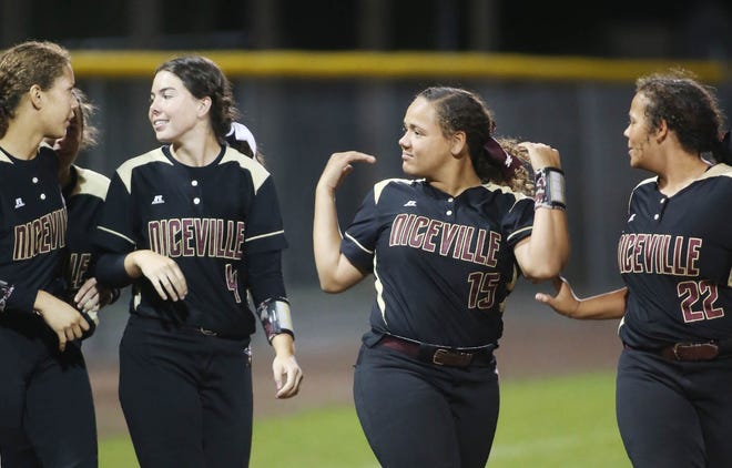Niceville softball players Sydney Byrd, Malana Bryant, and Raiven Bryant leave the field after a victory against MIlton. [MICHAEL SNYDER/DAILY NEWS]