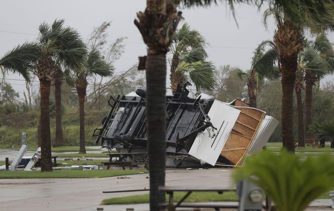 An overturned trailer sits in a park in the wake of Hurricane Harvey on Aug. 27 in Aransas Pass, Texas. Harvey is one of four names that will never again be used for storms. [The Associated Press]