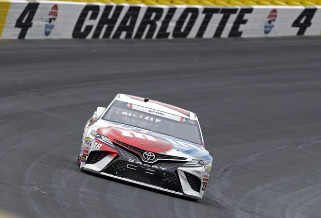 Kyle Busch (18) drives his car out of Turn 4 during the NASCAR Cup Series race at Charlotte Motor Speedway in Charlotte, N.C., on Sunday. [Chuck Burton/Associated Press]
