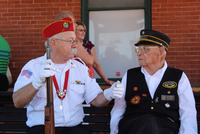 Mike Gibbs with the Fort Smith Marine Corps League, left, speaks to conductor Haskell Jeffries during "Troop Train" day at the Arkansas and Missouri Excursion Train depot in Van Buren on Saturday, May 26, 2018. Jeffries, the oldest railroad conductor in the United States and an Air Force veteran, was honored during a ceremony at the depot on Saturday morning. [MAX BRYAN/TIMES RECORD]