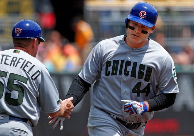 Chicago Cubs' Anthony Rizzo (44) rounds third to greetings from coach Brian Butterfield (55) after hitting a solo home run off Pittsburgh Pirates starting pitcher Chad Kuhl in the second inning of a baseball game in Pittsburgh, Monday, May 28, 2018. (AP Photo/Gene J. Puskar)
