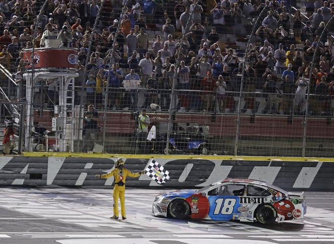 Kyle Busch celebrates after winning at Charlotte Motor Speedway on Sunday night. [AP Photo/Chuck Burton]