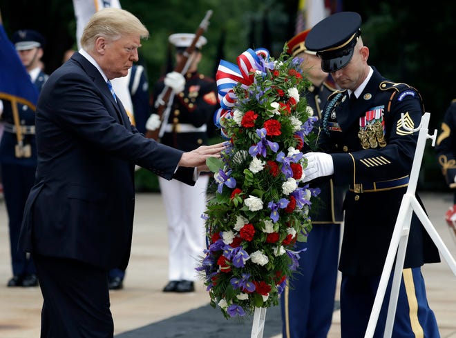 President Donald Trump lays a wreath at the Tomb of the Unknown Solider at Arlington National Cemetery, Monday, May 28, 2018, in Arlington, Va. (AP Photo/Evan Vucci)