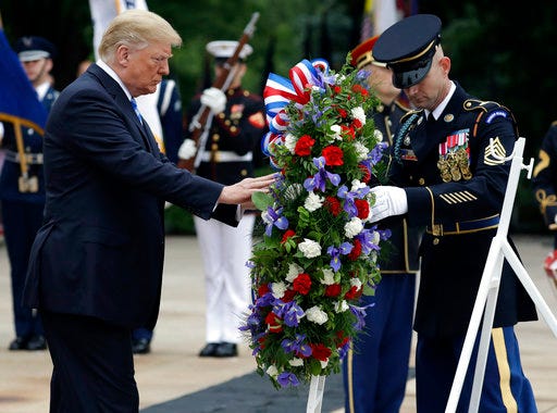 President Donald Trump lays a wreath at the Tomb of the Unknown Solider at Arlington National Cemetery, Monday, May 28, 2018, in Arlington, Va. (AP Photo/Evan Vucci)