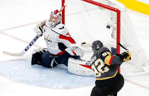 Washington Capitals goaltender Braden Holtby, left, is scored on by Vegas Golden Knights left wing Tomas Nosek, of the Czech Republic, during the third period in Game 1 of the NHL hockey Stanley Cup Finals Monday, May 28, 2018, in Las Vegas. (AP Photo/Ross D. Franklin)