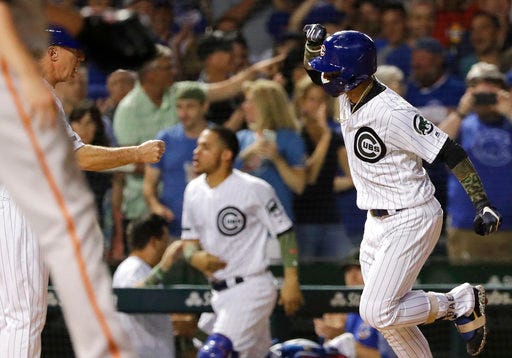 Chicago Cubs' Javier Baez, right, celebrates with third base coach Brian Butterfield after hitting a three-run home run during the fourth inning of a baseball game against the San Francisco Giants in Chicago, Sunday, May 27, 2018. (AP Photo/Nam Y. Huh)
