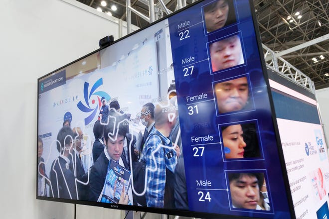 A facial recognition system shows visitors' faces and ages during the second AI Expo at Tokyo Big Sight in April, Tokyo, Japan. [RODRIGO REYES MARIN/AFLO/ZUMA PRESS/TNS]