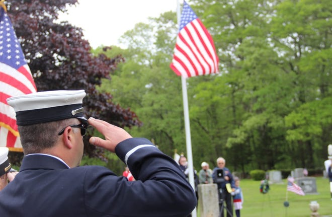 Dartmouth firefighters salute the flag at South Dartmouth Cemetery during the playing of taps. [PHIL DEVITT/SCMG]