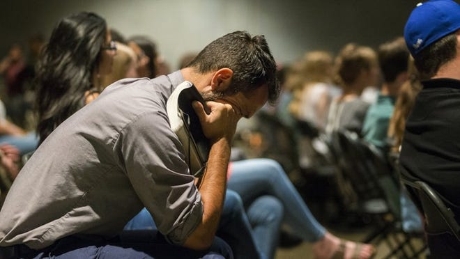 Peter Coelho listens to Church of the Violet Crown Pastor Aaron Reyes speak during a worship service called Standing with Dreamers in North Austin on May 17. (Stephen Spillman / for American-Statesman)