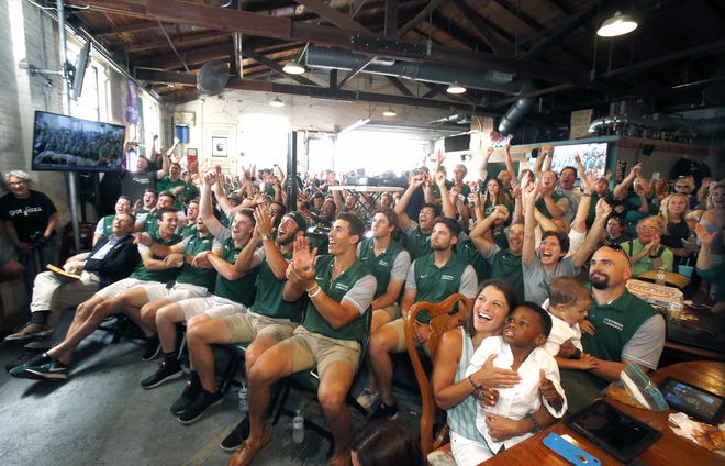 Stetson baseball players and fans react Monday at Persimmon Hollow Brewing Co. in DeLand after the Hatters were selected the No. 1 seed in their region. Stetson will host an NCAA regional tournament that also includes Hartford, USF and Oklahoma State. [Nigel Cook/Gatehouse Media]
