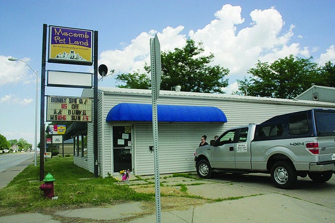 An animal control vehicle is seen in this photo taken Sunday facing the front entrance of Macomb Pet Land, 603 E. Jackson St.. The sign by the road reads "Bunny special." Eight bunnies were among the dead animals recovered from inside the building during a weekend investigation. [MICHELLE LANGHOUT/GateHouse Media Illinois]