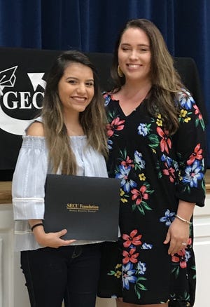 Ariana Ponce (left) has been the awarded the State Employees’ Credit Union “People Helping People” Scholarship by the organization’s representative Lauren Sowers (right). The $10,000 scholarship will be used by Ariana at University of North Carolina Wilmington in the Fall. [Submitted photo]