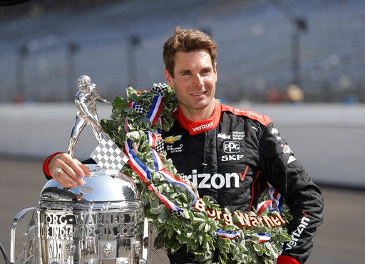 Indianapolis 500 champion Will Power, of Australia, poses with the Borg-Warner Trophy during the traditional winners photo session on the start/finish line at the Indianapolis Motor Speedway, Monday, May 28, 2018, in Indianapolis. (AP Photo/Darron Cummings)