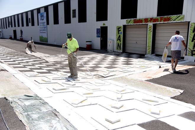 Crews repaint an area behind the grandstand at Pocono Raceway in Pocono Pines on Friday, May 25, 2018. Staff at the raceway have to prep the facility for three months worth of racing in just a few weeks due to harsh winter weather. [PATRICK CAMPBELL/POCONO RECORD]