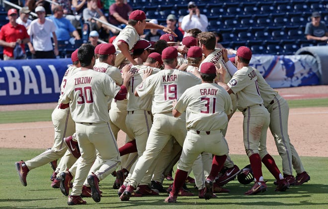 Florida State players celebrate after defeating Louisville on Sunday to win the Atlantic Coast Conference tournament championship in Durham, N.C. The Sminoles will host an NCAA regional this weekend. [Gerry Broome/The Associated Press]