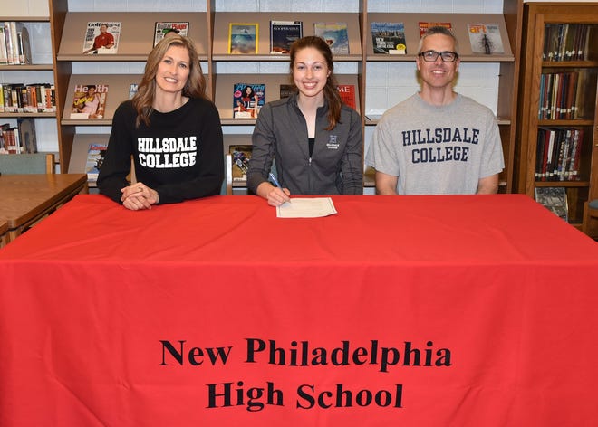 New Philadelphia senior Samantha Malcolm signs her letter of Intent to play volleyball at Hillsdale College in Michigan. Pictured with Samantha are her mother, LaNae, and father, Jay. Submitted photo